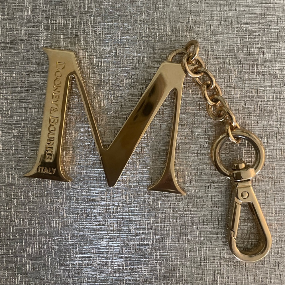 Beautiful Dooney Bourke Gold Toned “M” initial bag charm or key chain. Brand New